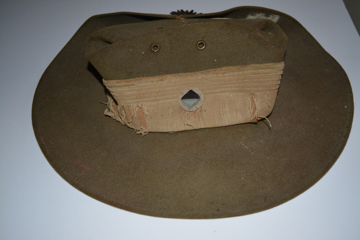 Dark and light blue diamond patch attached to hat band/pugaree.