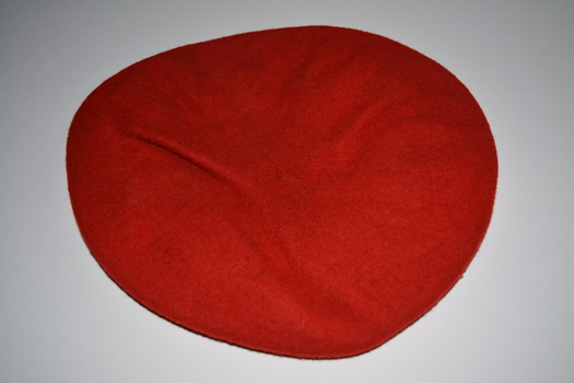 Red felt beret with black lining and edged in black leather