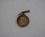 Round white metal medal with bent bar attachment