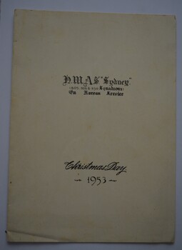 Cream coloured cardboard folded in half with black print on cover.