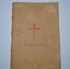 Cream colour cardboard cover booklet with red cross on cover containing 80 pages.