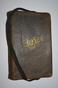 Black leather-bound covered booklet with black ribbon attached.