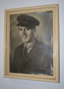 Cream colour frame containing black and white photograph of serviceman in Army uniform.