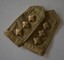 Two khaki fabric epaulettes each with three stars in a row and “Australia”stitched at one end