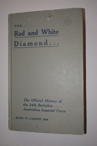 Dark blue hardback covered book with gold lettering on cover and spine.  The book is cover is encased in clear plastic.