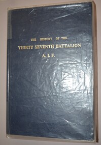 Dark blue hardback covered book with gold lettering on cover and spine.  The book is cover is encased in clear plastic.