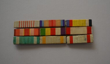 
Set of nine in three rows of striped medal ribbons in various colours.
