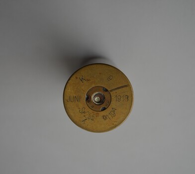 Small brass round shaped cylinder with rimmed base.