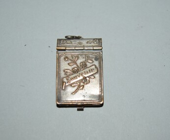 Round in shape with crown on top badge with rising sun in centre circle surrounded by lettering. One lug attached on reverse.
