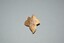 Small leaf shaped gold brooch with three leg symbol or Triskelion in the centre with hinged pin attached at rear.