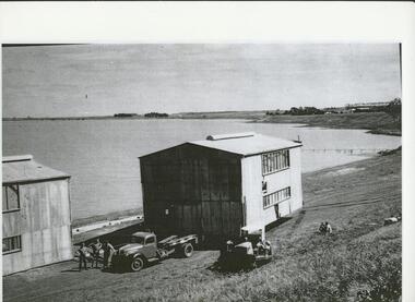 Black and white photograph, Aquatic Club building relocation from Flax Mill