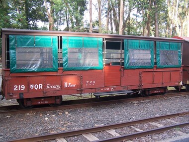 219 NQR - Open medium truck with seats & canopy, between 1990 and 1992