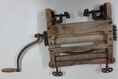 Wooden frame mangle, with rubber coated rollers, and metal fixtures.