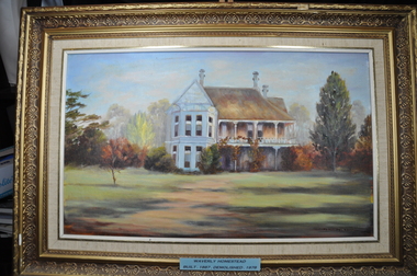 Painting of a white house with a brown roof surrounded by trees, in a gold frame.