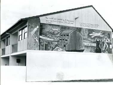 Black and white photograph of a mural on the side of a house.