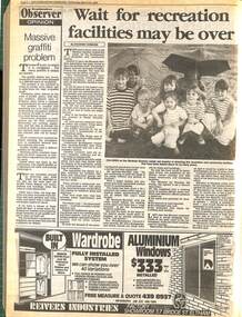 A newspaper article with the heading "Wait for recreation facilities may be over" with a picture of children sitting on the ground holding up umbrellas.