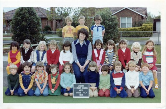 Formal Class photograph, Children are in three Rows, the front Row Kneeling, Centre of the second row is an adult.