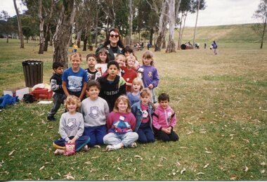 Group of children sitting on the grass