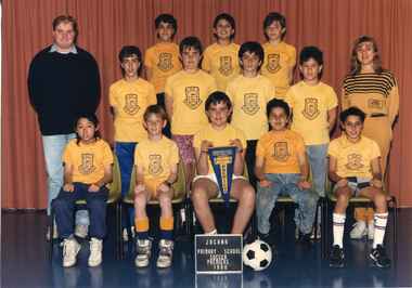Team Photograph of children in three rows, with adults on each end of the second row. 