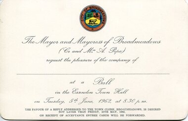 Cream printed invitation card issued by the Mayor and Mayoress of Broadmeadows, featuring a coloured municipal seal at the top and formal script inviting attendance at a civic ball at Essendon Town Hall on 5 June 1962, with a plain verso showing a small accession label.