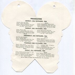 Die-cut cream paper programme opened flat, resembling a fan shape with rounded lobes and a central fold. Black printed text lists a multi-day programme for the Broadmeadows Festival of Arts, dated Monday 23rd November to Friday 27th November 1964, including choirs, orchestras, gymnastic groups, and theatrical performances. A small circular hole is visible near the top
