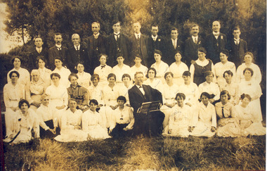 Postcard in sepia of Chelsea Choral Society taken in 1917. A framed version presented to Fred Frewin choirmaster (seated in front row) for services.