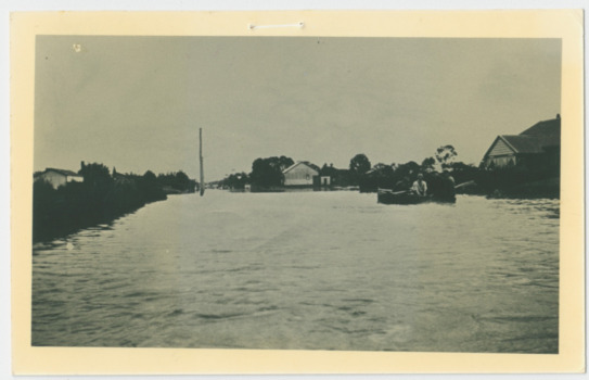 P00062 Men in lifeboat taking supplies to Wells Rd farms 1934 Postcard