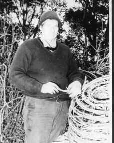 Photograph, 000119 - Photograph - October 1987 - Bob Young repairing crayfish pots