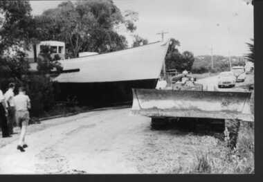 Photograph, Ripple 2 crossing Surf Parade pulled by dozer with Tom Anthony, Morrie Cargill  -  29 Nov 1959