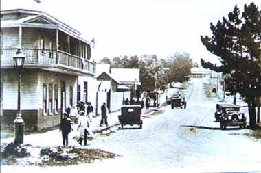 000467 Photograph - Photo of sepia photo - A’Beckett St Inverloch c1926 - gas lamp post, hotel, shops, cars - pedestrians, Bob Richardson