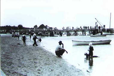 Photograph - Western side of Inverloch Pier from the 1920s with crane, boats and people enjoying the beach, 000514 - Photograph - 1920's Inverloch Pier