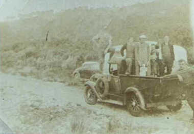 000542 - Photograph - Whippet Y utility truck on the road with six adults, one child and one dog on-board - Willys Clyde's mum, Cath Sparks, Clyde - from Clyde Newton