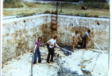 000667 - Photograph - 1976 - Inverloch - Pine Lodge Swimming pool being cleaned by Fire Brigade, Geoff Deacon and wife in foreground - from N Deacon