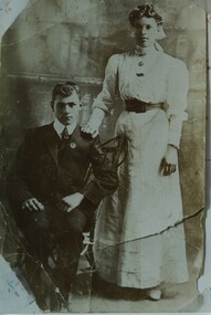 000963 - Photograph - Portrait of man seated woman standing - family letter on back - from Isobel Treadwell