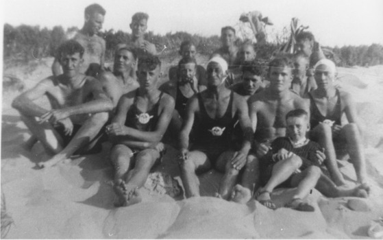 Group of surf lifesavers posed on sand Lakes Entrance beach