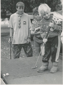 Photograph - First Sea Scouts Toorloo Arm, First Sea Scouts Toorloo Arm playing mini golf at St Nicholas Fete Mathew Purdon Adam May watching Daniel Ramsdell in action Lakes Entrance Victoria, 1/01/1992 12:00:00 AM