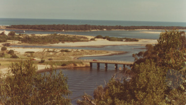 Photograph - North Arm Bridge, road to Bullock Island, build up of sand spit later site for Fishing Club and boat ramp, Lakes Entrance Victoria, G W Holding, 1/04/1979 12:00:00 AM