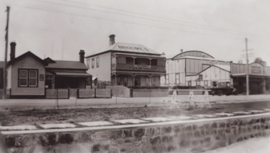 Photograph - Broomes Maranui , Police Station on the western side ,picture theatre on the eastern side. In foreground is the stone wall beside the lake, concrete path and picnic table beside the Esplanade Lakes Entrance Victoria, 1938 c