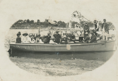 Postcard - Fourteen people on an outing on a boat at Lakes Entrance, c1900
