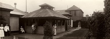 Exterior view, Isolation Ward, Children's Hospital, Carlton, circa 1920. Long shot of exterior of Children's Hospital. Staff are holding children in the photograph.