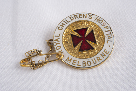 Royal Children's Hospital Nurse's badge, metal with enamel inlay, decorated with text and red cross emblem