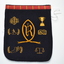 Navy blue wool blazer pocket with school crest and other symbols embroidered in yellow gold thread.