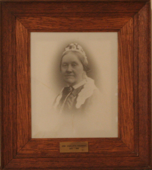 A head and shoulders portrait of a middle aged woman wearing a lace cap.