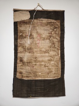 Image of the verso of the thangka, with significant water damage evident