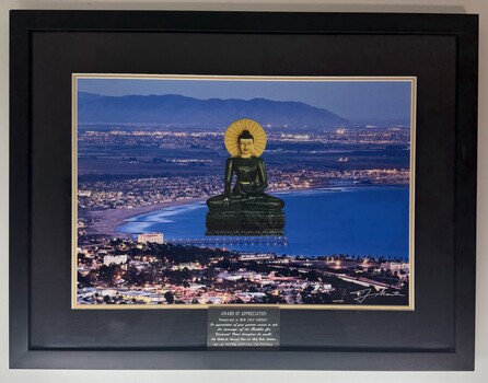 Framed image of Jade Buddha imposed over a beach setting with award of appreciation plaque to Mr. Ian Green.