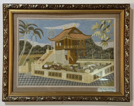 Framed embroidery of one pillar pagoda with message to Ian Green 'for your kindness'.
