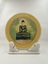 Front of marble souvenir plate on marble stand with print of the Jade Buddha