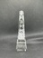 Side of circular glass award with engraving of maple leaf and text