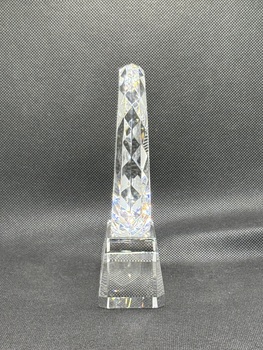 Side of circular glass award with engraving of maple leaf and text