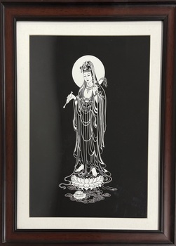 A framed print of Quan Yin in black and white